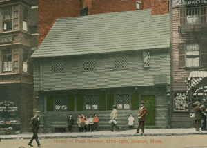 Postcard image of the Paul Revere House after restoration. Children pose in a group in red and white shirts.