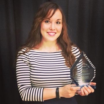 Professor Carrington Farmer holding an award